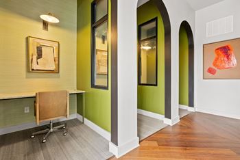 A room with a green wall and a brown chair.